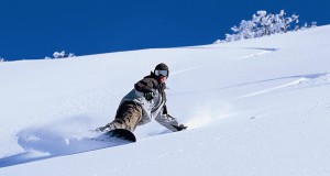 Man snowboarding down mountain