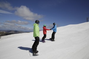 Snowboarders backwards on slopes