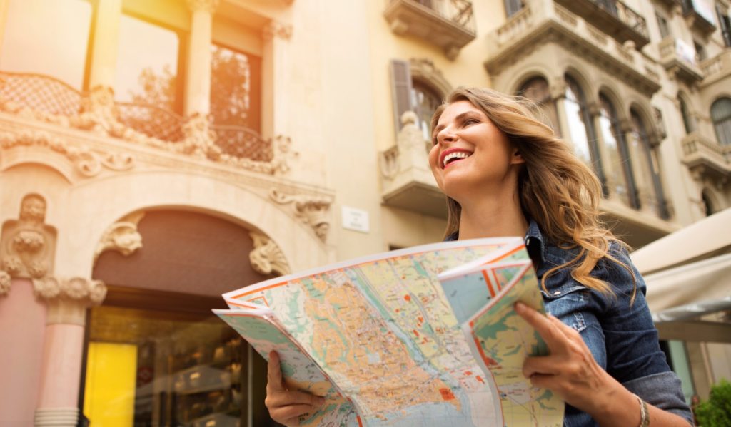 Female individual traveller with map